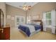 Bright primary bedroom with a ceiling fan, large windows, and access to the outdoor patio at 124 Corral Cir, Summerville, SC 29485