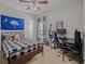 Teen bedroom with a cool design featuring a South Carolina flag, a plaid comforter, and musical instruments at 124 Corral Cir, Summerville, SC 29485