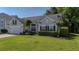 Charming single-Gathering home features manicured lawn, trimmed hedges, and two-car garage at 124 Corral Cir, Summerville, SC 29485