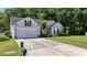 Well-maintained home with a two-car garage, manicured lawn, and mature landscaping at 124 Corral Cir, Summerville, SC 29485