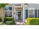Close-up of a welcoming front entrance with decorative glass door and manicured shrubbery at 124 Corral Cir, Summerville, SC 29485
