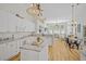 Spacious kitchen with island, white cabinets, granite countertops, open to living and dining areas at 124 Corral Cir, Summerville, SC 29485