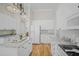 Bright kitchen features white cabinets, granite countertops, wood floors and stainless appliances at 124 Corral Cir, Summerville, SC 29485