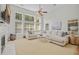 Spacious living room features a fireplace, large windows for natural light, and a cozy sectional sofa at 124 Corral Cir, Summerville, SC 29485