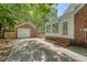 View of the backyard featuring a detached garage, a fence, and access to the sunroom at 13 Charlestowne Rd Rd, Charleston, SC 29407