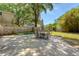 Backyard patio with outdoor dining table, well-maintained lawn and surrounding privacy fence at 13 Charlestowne Rd Rd, Charleston, SC 29407