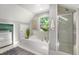 Bathroom featuring a bathtub, shower and laundry area with a window providing natural light at 13 Charlestowne Rd Rd, Charleston, SC 29407