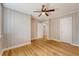 Bedroom featuring wood paneling, hardwood floors, and a ceiling fan at 13 Charlestowne Rd Rd, Charleston, SC 29407