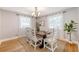 Cozy dining room with rustic table, six chairs, chandelier, and hardwood floors at 13 Charlestowne Rd Rd, Charleston, SC 29407