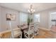 Charming dining area with six chairs, a decorative table, hardwood flooring, and natural light at 13 Charlestowne Rd Rd, Charleston, SC 29407