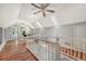 Bright hallway with hardwood floors, skylights, and a view into the bathroom at 13 Charlestowne Rd Rd, Charleston, SC 29407