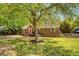 Charming brick home with a red front door, well-maintained lawn, and mature trees at 13 Charlestowne Rd Rd, Charleston, SC 29407