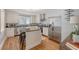 Spacious kitchen with island seating, stainless appliances, and wood floors at 13 Charlestowne Rd Rd, Charleston, SC 29407