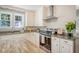 Bright kitchen featuring granite countertops, stainless steel appliances, and white cabinets at 13 Charlestowne Rd Rd, Charleston, SC 29407
