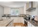 Well-lit kitchen with an island, granite counters, and stainless steel appliances at 13 Charlestowne Rd Rd, Charleston, SC 29407