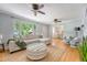 Open-concept living room with hardwood floors, modern decor and access to the dining room at 13 Charlestowne Rd Rd, Charleston, SC 29407