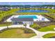 Aerial view of a community pool and pond surrounded by lush green landscaping and modern homes at 131 Beargrass Ln, Summerville, SC 29486