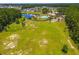 Aerial view of community pool, lake, and neighborhoods surrounded by forested areas at 131 Beargrass Ln, Summerville, SC 29486