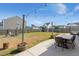 Expansive backyard with dining set, fire pit, lounge, and landscaping features at 131 Beargrass Ln, Summerville, SC 29486