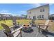 Backyard featuring a firepit with Adirondack chairs, a lush lawn, and a patio with outdoor seating at 131 Beargrass Ln, Summerville, SC 29486