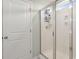 Bathroom featuring a walk-in shower with glass door, shelving, and white walls at 131 Beargrass Ln, Summerville, SC 29486