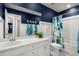 Bathroom featuring white cabinetry, blue accent wall, and tub with shower featuring decorative curtain at 131 Beargrass Ln, Summerville, SC 29486