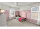A bedroom featuring pink walls with a style bed that has windows on two sides at 131 Beargrass Ln, Summerville, SC 29486