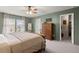 Bedroom with a green paint featuring a view to the backyard, wooden furniture and light colored carpet at 131 Beargrass Ln, Summerville, SC 29486