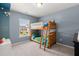 Light blue bedroom with a wood bunk bed and natural light from the window at 131 Beargrass Ln, Summerville, SC 29486