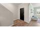Warm and inviting entryway featuring wood-look flooring, a black front door, and decorative wainscoting at 131 Beargrass Ln, Summerville, SC 29486