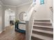 Open foyer showcasing a staircase, hardwood floors, stylish console table, and an arched entryway at 131 Beargrass Ln, Summerville, SC 29486