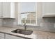 Granite counters and stainless steel sink complement the subway tile backsplash at 131 Beargrass Ln, Summerville, SC 29486