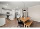 Open kitchen and dining area featuring white cabinets, stainless steel appliances, and wood floors at 131 Beargrass Ln, Summerville, SC 29486