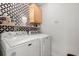 Laundry room featuring stacked washer and dryer and decorative black and white patterned wall at 131 Beargrass Ln, Summerville, SC 29486