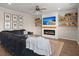 Cozy living room with a large sectional, electric fireplace, mounted TV, and custom shelving at 131 Beargrass Ln, Summerville, SC 29486