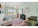 Bright playroom featuring a large window, comfortable seating, and stylish decor elements at 131 Beargrass Ln, Summerville, SC 29486