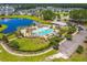 Aerial view of a community pool and facilities, surrounded by homes and a lake at 131 Beargrass Ln, Summerville, SC 29486