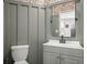 Stylish powder room featuring floral wallpaper, gray vanity, and modern black fixtures at 131 Beargrass Ln, Summerville, SC 29486