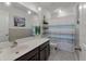Cozy bathroom with modern vanity, decorative mirror, and shower with striped curtain at 1311 Berry Grove Dr, Summerville, SC 29485