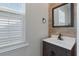 Stylish powder room featuring stone accent wall, modern vanity, and natural light at 1311 Berry Grove Dr, Summerville, SC 29485