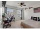 Well-lit bedroom with ceiling fan, large windows, desk area, and sports-themed decor at 1311 Berry Grove Dr, Summerville, SC 29485