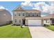 Charming two-story home features a two-car garage, neutral siding, and well-maintained lawn at 1311 Berry Grove Dr, Summerville, SC 29485