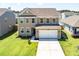 Charming two-story home with a well-kept lawn and a two-car garage, creating curb appeal at 1311 Berry Grove Dr, Summerville, SC 29485