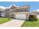 Well-maintained home with a two-car garage, tidy landscaping, and a concrete driveway at 1311 Berry Grove Dr, Summerville, SC 29485