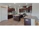 Well-equipped kitchen with stainless steel appliances, an island, and stylish dark wood cabinetry at 1311 Berry Grove Dr, Summerville, SC 29485