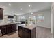 Modern kitchen with stainless appliances, granite counters, dark cabinets and attached living area at 1311 Berry Grove Dr, Summerville, SC 29485