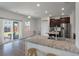 Modern kitchen features stainless steel appliances, granite countertops, and sliding glass door to the back yard at 1311 Berry Grove Dr, Summerville, SC 29485