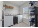 Functional laundry room featuring a washer, dryer, storage shelving, and natural light at 1311 Berry Grove Dr, Summerville, SC 29485