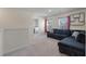 Upstairs living room with a grey sectional sofa, laundry room, and natural light at 1311 Berry Grove Dr, Summerville, SC 29485