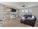 Living room showcases a feature wall, a leather couch, and a ceiling fan at 1311 Berry Grove Dr, Summerville, SC 29485